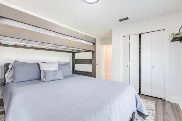 Bedroom with queen bed and bunk above