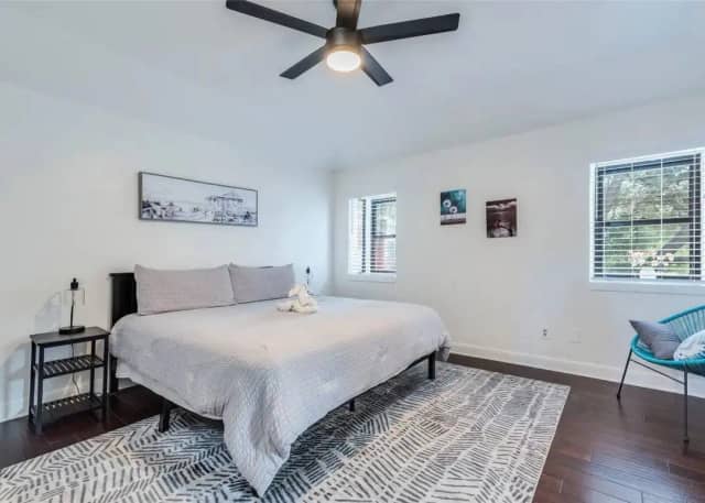 Guest bedroom with king bed and ceiling fan