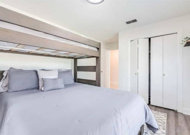 Bedroom with queen bed and bunk above