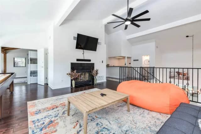 Game room with fireplace and shuffleboard