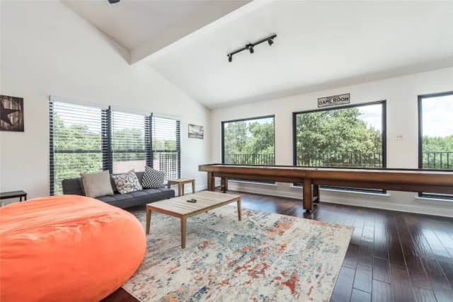 Game room with shuffleboard table and bean bag