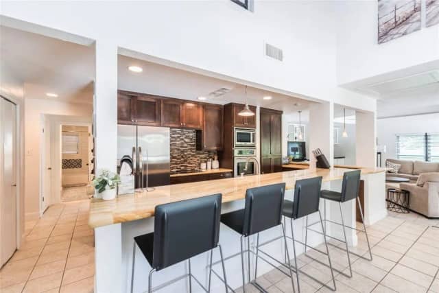 Kitchen with bar seating and stainless appliances