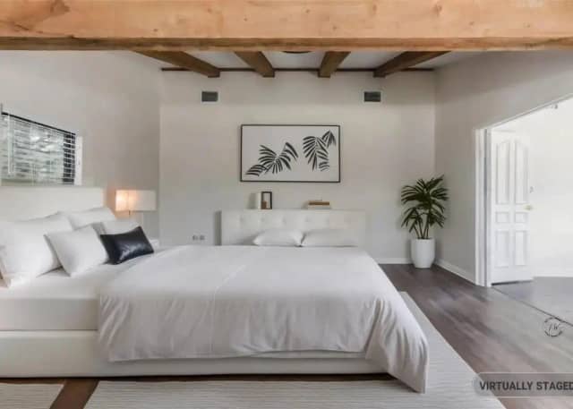Master bedroom with exposed beams and king beds