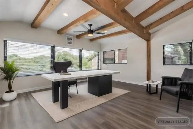 Home office with exposed wood beams