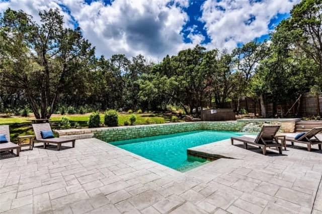 Pool with lounge chairs and hot tub